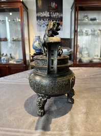 A large Chinese bronze censer and cover with a Buddhist lion, Ming