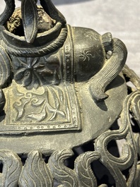 A Chinese bronze 'elephant' tripod censer and cover, Ming