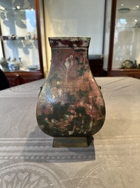 A Chinese archaic bronze vase with 'Taotie' handles, 'fang hu 方壺', Han