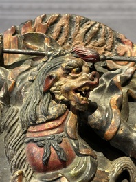 A Chinese bronze Guanyin, Ming and a Tibetan polychrome plaster relief, 19th C.