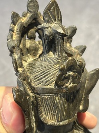 A Chinese bronze Guanyin, Ming and a Tibetan polychrome plaster relief, 19th C.
