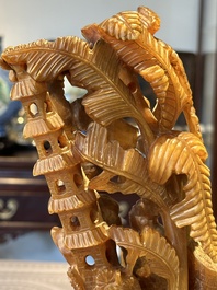 A Chinese buffalo horn carving of a landscape with a pagoda on wooden stand, Qing