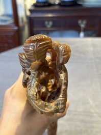 A Chinese buffalo horn carving of a landscape with a pagoda on wooden stand, Qing