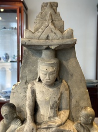 A Burmese limestone stele with Buddha and two attendants with traces of gilding, 19th C.