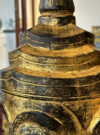 A Thai red sandstone head of Buddha and a lacquered and gilt stone head of Buddha, possibly Ayutthaya period, 15th C.
