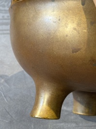 A large Chinese bronze tripod censer with two handles, 19th C.