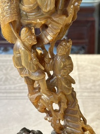A Chinese buffalo horn carving of a landscape with a pagoda on wooden stand, Qing