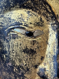 A Thai red sandstone head of Buddha and a lacquered and gilt stone head of Buddha, possibly Ayutthaya period, 15th C.