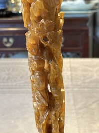 A Chinese buffalo horn carving of a landscape with a pagoda on wooden stand, Qing