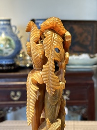 A Chinese buffalo horn carving of a landscape with a pagoda on wooden stand, Qing