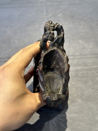 A Chinese buffalo horn carving of a landscape with a pagoda on wooden stand, Qing