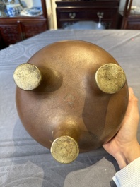 A large Chinese bronze tripod censer with two handles, 19th C.