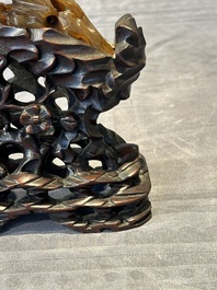 A Chinese buffalo horn carving of a landscape with a pagoda on wooden stand, Qing