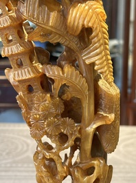 A Chinese buffalo horn carving of a landscape with a pagoda on wooden stand, Qing