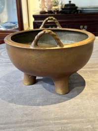 A large Chinese bronze tripod censer with two handles, 19th C.