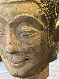 A Thai red sandstone head of Buddha and a lacquered and gilt stone head of Buddha, possibly Ayutthaya period, 15th C.