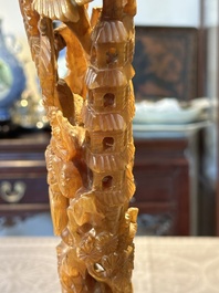A Chinese buffalo horn carving of a landscape with a pagoda on wooden stand, Qing