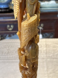 A Chinese buffalo horn carving of a landscape with a pagoda on wooden stand, Qing