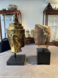 A Thai red sandstone head of Buddha and a lacquered and gilt stone head of Buddha, possibly Ayutthaya period, 15th C.