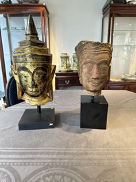 A Thai red sandstone head of Buddha and a lacquered and gilt stone head of Buddha, possibly Ayutthaya period, 15th C.