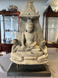 A Burmese limestone stele with Buddha and two attendants with traces of gilding, 19th C.