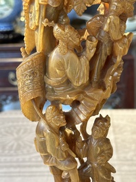 A Chinese buffalo horn carving of a landscape with a pagoda on wooden stand, Qing