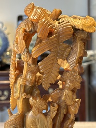 A Chinese buffalo horn carving of a landscape with a pagoda on wooden stand, Qing