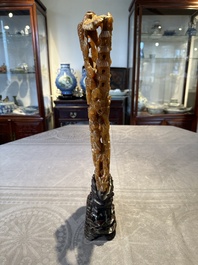 A Chinese buffalo horn carving of a landscape with a pagoda on wooden stand, Qing