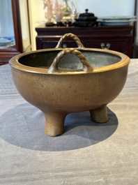 A large Chinese bronze tripod censer with two handles, 19th C.