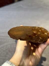 A Chinese buffalo horn carving of a landscape with a pagoda on wooden stand, Qing