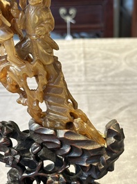 A Chinese buffalo horn carving of a landscape with a pagoda on wooden stand, Qing