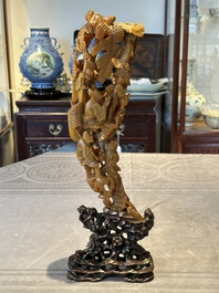 A Chinese buffalo horn carving of a landscape with a pagoda on wooden stand, Qing