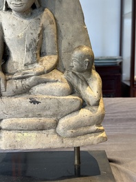 A Burmese limestone stele with Buddha and two attendants with traces of gilding, 19th C.