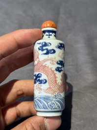 A Chinese blue, white and copper-red 'dragon' snuff bottle, 19th C.