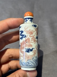 A Chinese blue, white and copper-red 'dragon' snuff bottle, 19th C.