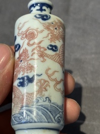 A Chinese blue, white and copper-red 'dragon' snuff bottle, 19th C.