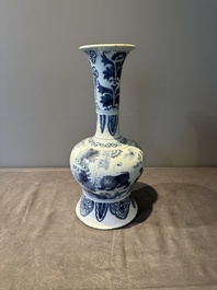 A blue and white Dutch Delft bottle-shaped chinoiserie vase with a lion, 17th C.