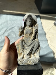 A Gandhara grey schist sculpture of the Bodhisattva Maitreya, a sculpture of a master with a child and a fragment of a divinity, 1/5th C.