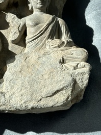 A Gandhara grey schist fragment of a seated Buddha with his disciple and a fragment with five figures, 1st/3rd C.