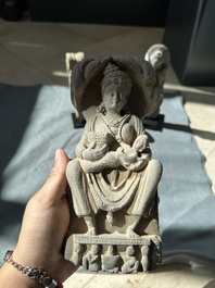 A Gandhara grey schist sculpture of the Bodhisattva Maitreya, a sculpture of a master with a child and a fragment of a divinity, 1/5th C.