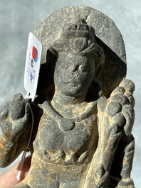 A Gandhara grey schist sculpture of the Bodhisattva Maitreya, a sculpture of a master with a child and a fragment of a divinity, 1/5th C.