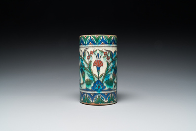 A polychrome Iznik-style mug with tulips and carnations, Kutahya, Turkey, 19th C.
