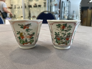 A Chinese wucai rouleau vase and a pair of octagonal cups with floral design, Transitional period/Kangxi