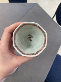 A Chinese wucai rouleau vase and a pair of octagonal cups with floral design, Transitional period/Kangxi