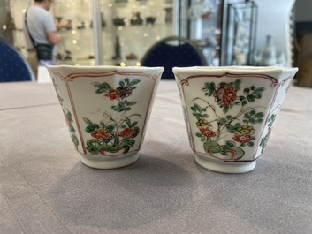 A Chinese wucai rouleau vase and a pair of octagonal cups with floral design, Transitional period/Kangxi