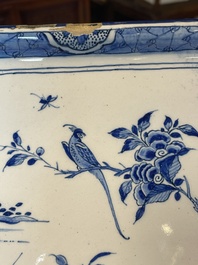 A blue and white Dutch Delft chinoiserie plaque with a tea drinking scene, 18th C.