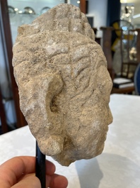 A sandstone torso and a Buddha head, Cambodia, late Khmer period, 13/14th C.
