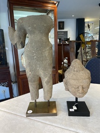 A sandstone torso and a Buddha head, Cambodia, late Khmer period, 13/14th C.