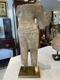 A sandstone torso and a Buddha head, Cambodia, late Khmer period, 13/14th C.