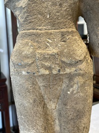 A sandstone torso and a Buddha head, Cambodia, late Khmer period, 13/14th C.